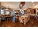 Open kitchen boasts an island, breakfast nook, and stone accents at 8871 Aspen Leaf Ct, Littleton, CO 80125