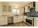 Modern kitchen with stainless steel appliances and white cabinets at 8470 Decatur St # 89, Westminster, CO 80031