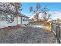 Fenced backyard with a grassy area and a view of a neighboring home at 740 Fulton Ave, Fort Lupton, CO 80621