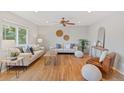 Spacious living room with lots of seating, hardwood flooring, and a ceiling fan at 2155 S Deframe St, Lakewood, CO 80228