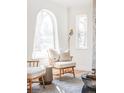 Bright living room featuring an arched window, wood floors, and natural light at 1117 Jersey St, Denver, CO 80220