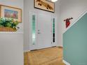 Bright foyer showcasing hardwood floors and modern accents at 2716 W Greens Dr, Littleton, CO 80123