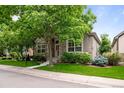 Attractive single-Gathering home with stone accents, mature trees, and a lush green lawn at 6900 W Grant Ranch Blvd # 88, Denver, CO 80123