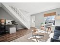 Cozy living room with natural light, wood floors, and neutral decor at 2105 Coronado Pkwy # C, Denver, CO 80229