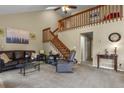 Spacious living room with vaulted ceilings, a staircase, and carpet flooring at 5317 W Iliff Dr # 101, Lakewood, CO 80227