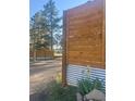 Driveway featuring a new wooden fence, white flowers, and trees in the background at 34480 County Road 17, Elizabeth, CO 80107