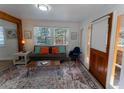 Cozy living room features bright windows, stylish rug, and comfortable seating, creating an inviting space at 34480 County Road 17, Elizabeth, CO 80107