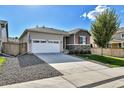Charming home showcasing a two-car garage and a well-maintained front yard with mature landscaping at 27862 E 9Th Dr, Aurora, CO 80018
