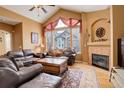 Inviting living room with vaulted ceiling, fireplace, large windows, and comfortable leather furniture set at 2855 Rock Creek Cir # 129, Superior, CO 80027