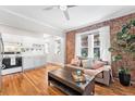 Cozy living room with exposed brick wall, hardwood floors, and modern furnishings at 1351 N Washington St # 15, Denver, CO 80203