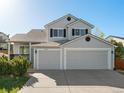 A well-maintained home featuring a three car garage and manicured landscaping at 16212 Blueleaf Pl, Parker, CO 80134