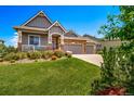 Inviting home with a well-maintained lawn and a spacious three-car garage at 5439 Innisbrook Loop, Elizabeth, CO 80107