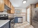 Efficient kitchen with stainless steel appliances and wood cabinets at 3050 S Delaware St, Englewood, CO 80110