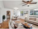 Bright living room featuring hardwood floors, neutral furniture, and dining area at 3050 S Delaware St, Englewood, CO 80110