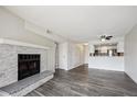 Open-concept living space with a cozy stone fireplace that leads to a modern kitchen with a breakfast bar at 4273 S Salida Way # 1, Aurora, CO 80013