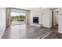 Bright living room with a cozy stone fireplace and large sliding glass door with natural light at 4273 S Salida Way # 1, Aurora, CO 80013