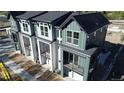 Aerial shot of modern townhomes with balconies and well-maintained landscaping at 11965 W 57Th Ln, Arvada, CO 80002