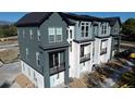 An elevated view of modern townhomes, featuring stone accents and balconies at 11965 W 57Th Ln, Arvada, CO 80002