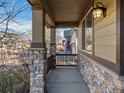 Inviting porch with stone columns and railings, offering a cozy outdoor space at 41 Garner Ln, Erie, CO 80516