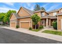 Inviting exterior showcasing the warm, neutral palette, complemented by a stone accent and well-kept landscaping at 11705 W Stanford Ln, Morrison, CO 80465