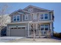 Two-story home boasts a neutral color scheme and attached two car garage at 8760 Ginkgo Loop, Parker, CO 80134