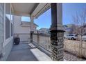 Front porch boasts a beautiful stone and beam column design at 8760 Ginkgo Loop, Parker, CO 80134