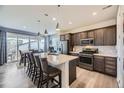 Modern kitchen with stainless steel appliances, a large island, and sleek countertops at 22255 E Mansfield Pl, Aurora, CO 80018