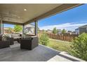 Covered patio with comfortable seating offers a relaxing outdoor living space at 22255 E Mansfield Pl, Aurora, CO 80018