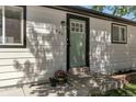 Close up of front entrance of home with fresh paint and potted plants at 251 Norse St, Golden, CO 80401