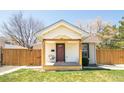Inviting front porch on this home with tidy lawn and wood fencing at 851 Quitman St, Denver, CO 80204