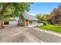 Well-maintained single-Gathering home with lush lawn, detached garage and inviting front porch at 2535 S Julian St, Denver, CO 80219