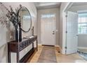 Welcoming entryway boasts stylish console table, sleek mirror, modern decor and natural light at 5789 Echo Park Cir, Castle Rock, CO 80104