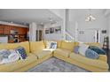 Bright living room with large yellow sectional sofa at 6817 S Webster St # C, Littleton, CO 80128