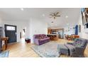 Spacious living room boasts hardwood floors and an open floor plan to the kitchen and dining area at 3071 S Truckee St, Aurora, CO 80013