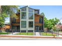 Contemporary two-story home showcases a unique design with a mix of wood and metal accents, and large windows at 2702 Lowell Blvd, Denver, CO 80211