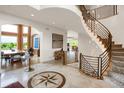 Elegant foyer with a grand staircase, decorative tile flooring, and views into adjacent living spaces at 2421 Ranch Reserve Rdg, Denver, CO 80234