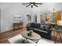 Comfortable living room area with hardwood floors, gray walls, and an open view to the adjacent rooms at 32252 Steven Way, Conifer, CO 80433