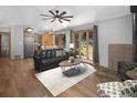 Inviting living room featuring a fireplace, wood floors, and expansive windows with views at 32252 Steven Way, Conifer, CO 80433
