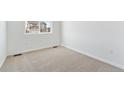 Bright bedroom with neutral carpet, white walls, and ample natural light at 9712 Cathay St, Commerce City, CO 80022