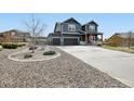 Charming two-story home features a large driveway, well-manicured landscaping, and a welcoming front porch at 795 Woodmoor Acres Dr, Monument, CO 80132