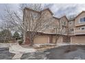 Townhome exterior displaying garages with brick accents at 6847 S Webster St # A, Littleton, CO 80128