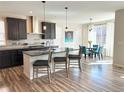 Modern kitchen features a large island with bar seating and stainless steel appliances at 9482 Kendrick Way, Arvada, CO 80007