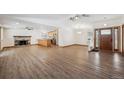 Spacious living room with a fireplace, wood floors, and plenty of natural light at 1843 S Pierson Ct, Lakewood, CO 80232