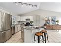 Spacious kitchen featuring stainless steel appliances, granite countertops, an island, and modern lighting at 1838 Wilson Cir, Erie, CO 80516