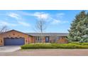 Charming red brick home featuring an attached garage and a well-manicured front yard at 2130 Frontier Ln, Franktown, CO 80116
