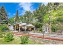 Cozy mountain home with covered parking and a charming greenhouse, surrounded by natural beauty at 4364 Colorado 103, Idaho Springs, CO 80452