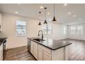 Bright kitchen featuring stainless steel appliances, a sleek countertop island, and ample natural light at 6874 Zuni Ct, Denver, CO 80221