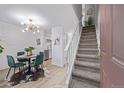 Open layout boasts a dining area, stairs to second level, and access to kitchen space at 1060 S Parker Rd # 36, Denver, CO 80231