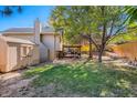 The backyard features a well-maintained lawn, a shed, a stone patio, and a mature shade tree at 21470 E Aberdeen Dr, Centennial, CO 80015