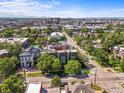 Expansive aerial view showcasing the city skyline, tree-lined streets and charming neighborhood at 2565 Champa St, Denver, CO 80205